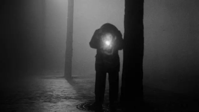 Man lighting a cigarette, Paris 1950