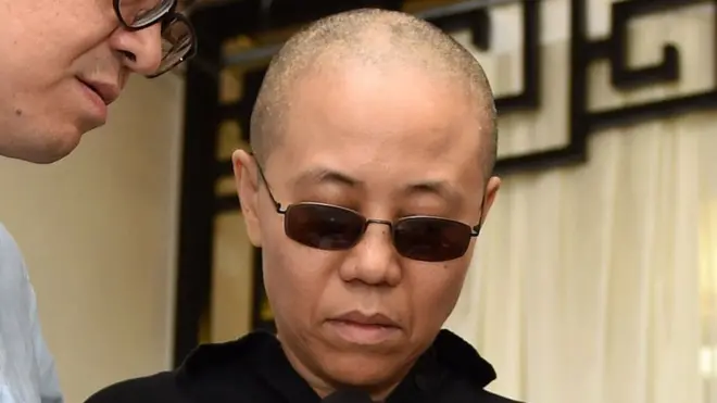 Liu Xia (C) holding a portrait of Liu Xiaobo in Shenyang, Liaoning province, on July 15, 2017