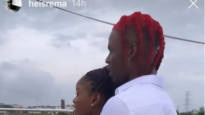 Rema hold Nimie for back