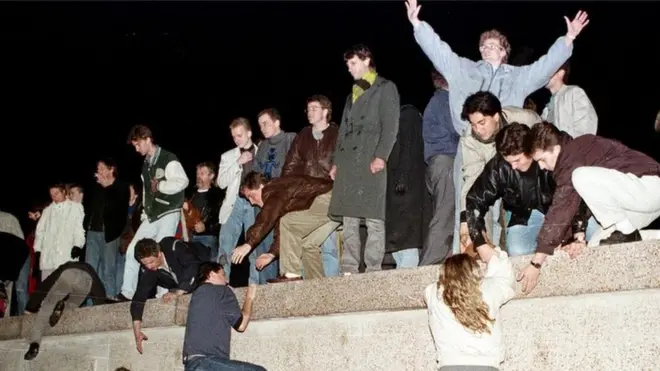 East Berliners scaled the Berlin Wall on 9 November 1989, bringing down the Iron Curtain in Germany