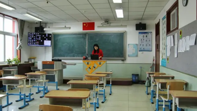 A teacher takes an online class at a middle school in Beijing in 2021