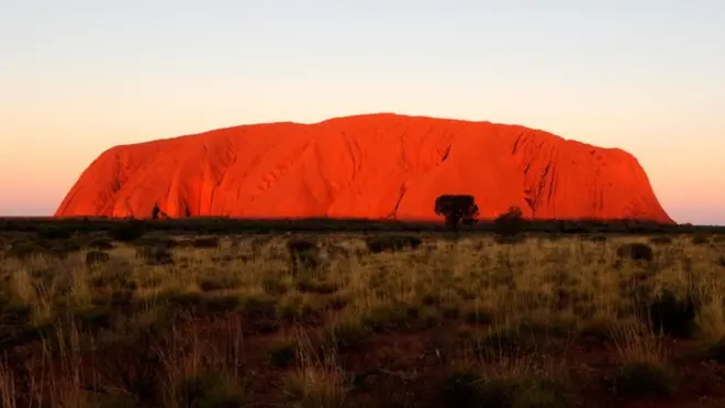 Climbing on the iconic monolith will be banned next year