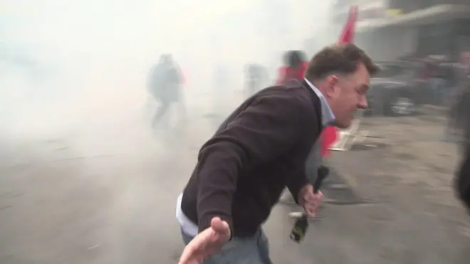 BBC correspondent Martin Patience flees tear gas