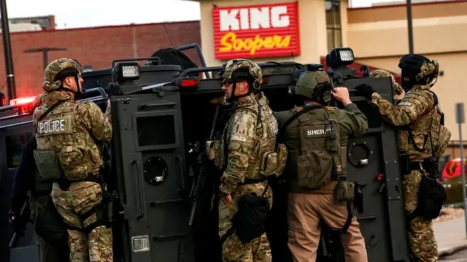Law enforcement officers in tactical gear are seen at the site of a shooting at a King Soopers grocery store in Boulder, Colorado