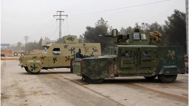 A rebel fighter from the Jaish al-Fatah (or Army of Conquest) brigades sits in a US-made Humvee (R) captured from the Iraqi army during a major assault on Syrian government forces West of Aleppo city on October 28, 2016.