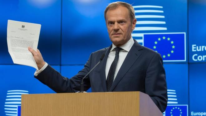 European Council president Donald Tusk holds the letter giving Britain"s official notice under Article 50 of the Lisbon Treaty to leave the European Union as he makes a statement at the EU Council in Brussels, Belgium, 29 March 2017