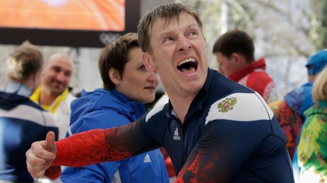 Bobsledder Aleksandr Zubkov celebrates winning a gold medal at Sochi 2014