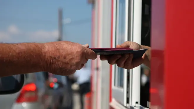 People have their passports checked at the site of the newly-opened Dherynia crossing, near the eastern village of Dherynia, separating the Republic of Cyprus and the self-proclaimed Turkish Republic of Northern Cyprus (TRNC) on November 12, 2018.