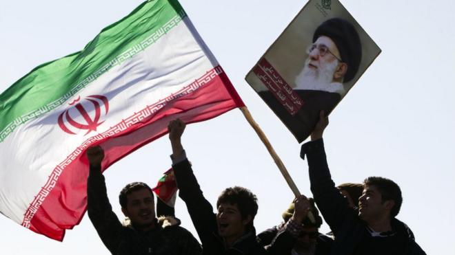 Iranians hold national flag and a picture of Ayatollah Khamenei (file photo)