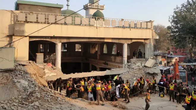 Rescue workers at the scene of a blast at a Mosque, in Peshawar, Pakistan,