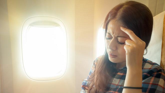 Worried woman on plane