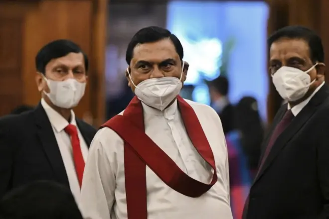 Sri Lanka's Minister of Finance Basil Rajapaksa (C), Minister of Finance Secretary S R Attygalle (R) and Governor of the Central Bank of Sri Lanka Ajith Nivard Cabraal (L) arrive at the official residence of the Prime Minister of Sri Lanka before their meeting with Chinese Foreign Minister Wang Yi (not pictured) and Sri Lanka's Prime Minister Mahinda Rajapaksa (not pictured) in Colombo on January 9, 2022.