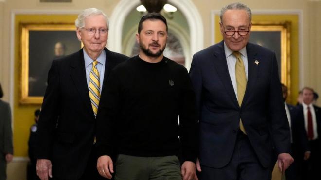 Volodymyr Zelensky walks with Mitch McConnell and Chuck Schumer as he arrives at the US Capitol