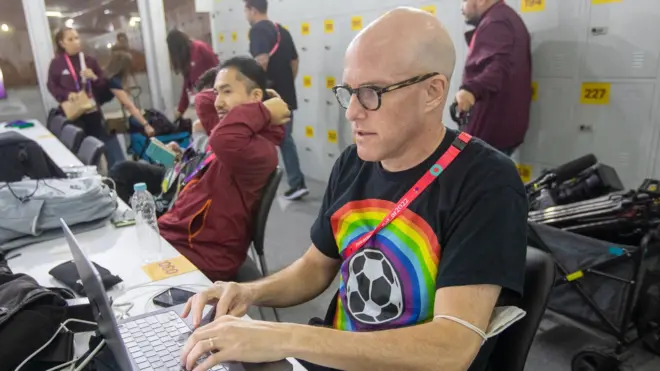 Grant Wahl works in the FIFA media centre in November