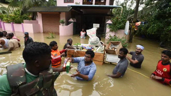 Volunteers distribute flood relief materials to residents at Pandanad in Chengannur Taluk on August 19, 2018 in Alappuzha, India