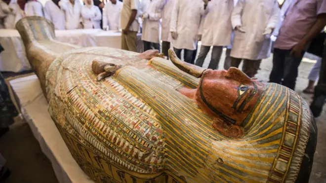 Employees of Egypt"s ministry of antiquities observe a sarchphagus displayed in front of Hatshepsut Temple in Egypt"s valley of the Kings in Luxor on October 19, 2019