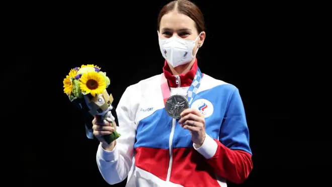 Roc team member display medal she win