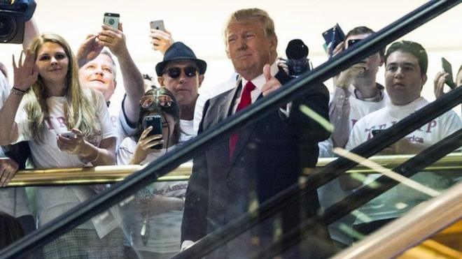 Donald Trump makes his entrance via a golden escalator