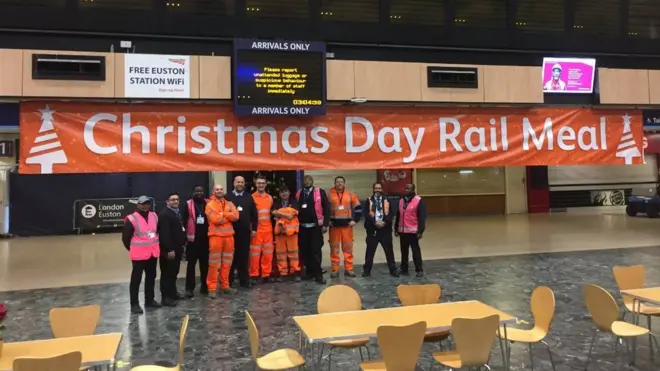 Volunteers standing in Euston Station