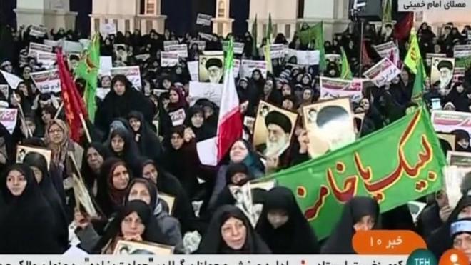crowds carrying flags