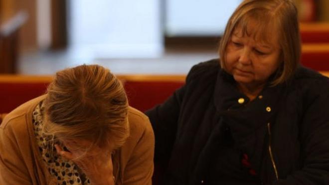 Constituent Ruth Verrinder and former councillor and mayor Judith McMahon (L) pay their respects at St Michael All Angels Church, following the stabbing of UK Conservative MP Sir David Amess.