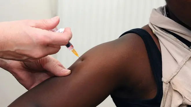 small pikin dey collect measles vaccine.