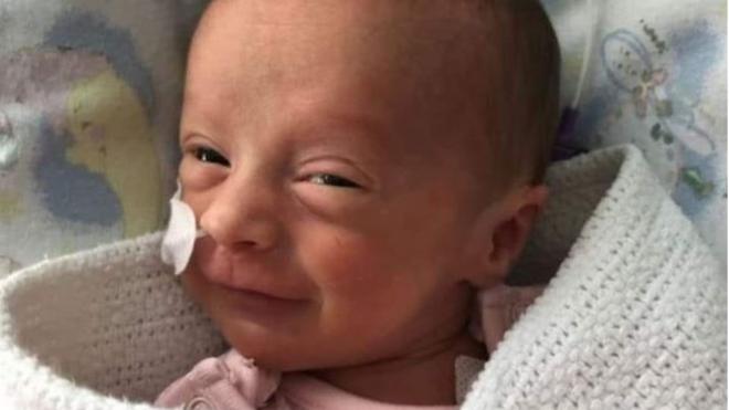 A smiling Peyton who fought off coronavirus just weeks after being born