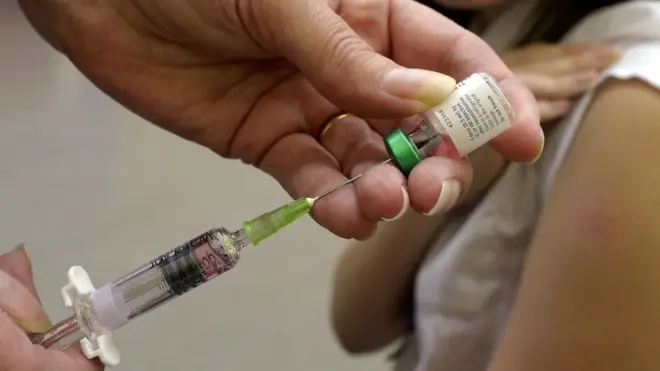 A child receiving a measles vaccination