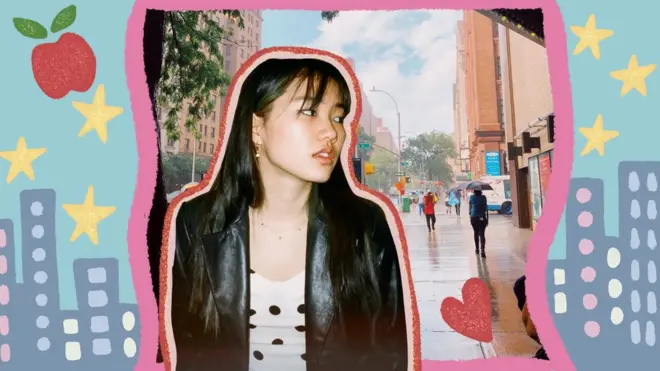 Arden in New York with illustrations of an apple, stars and skyscrapers behind her