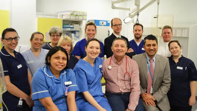 Ray Woodhall (front row centre) has returned to hospital to thank the medical team that saved him