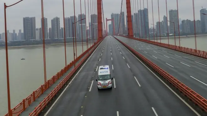 Photo: A largely empty eight lane road in Wuhan save for an ambulance