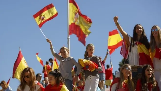demonstrators hold Spanish flags as they protest against the independence of Catalonia under the slogan "For the defense and unity of Spain" called by DENAES foundation at Colon Square on October 7, 2017 in Madrid, Spain.