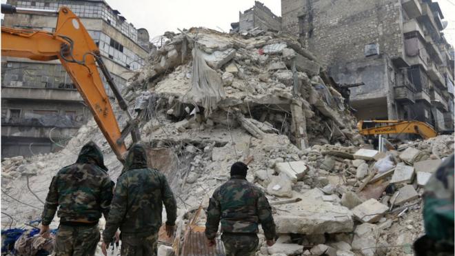 Syrian rescue teams search for victims and survivors at the rubble a collapsed building in the city of Aleppo