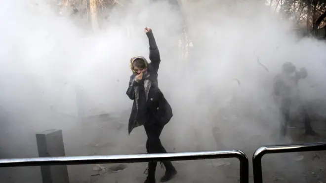 An Iranian woman raises her fist during a protest in Tehran on 30 December 2017