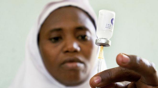 Nurse preparing a vaccine shot in a clinic in Nigeria