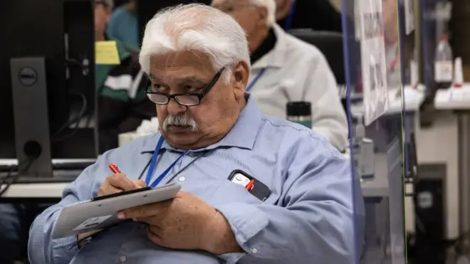 An adjudication board member reviewing ballots in Arizona's Maricopa County on 9 November