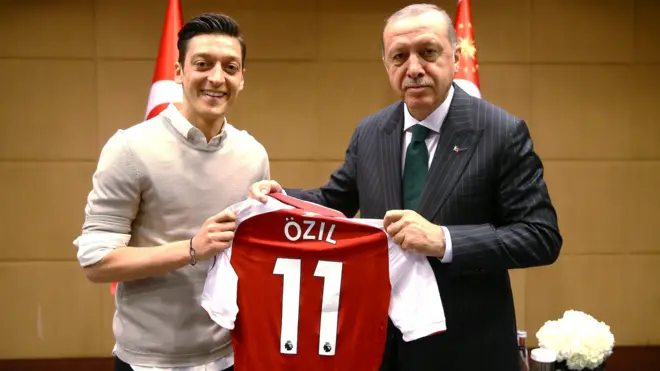 Mesut Ozil handsTurkish president Recep Tayyip Erdogan a signed shirt