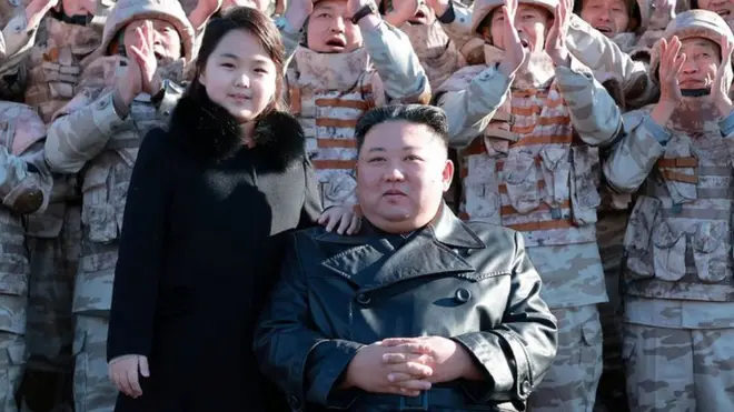North Korean leader Kim Jong Un and his daughter attend a photo session with the scientists, engineers, military officials and others involved in the test-fire of the country's new Hwasong-17 intercontinental ballistic missile