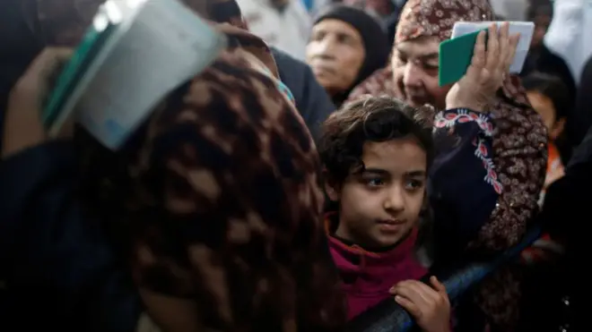 Palestinian refugees wait to receive aid at a United Nations food distribution centre in Al-Shati refugee camp in Gaza City January 15, 2018