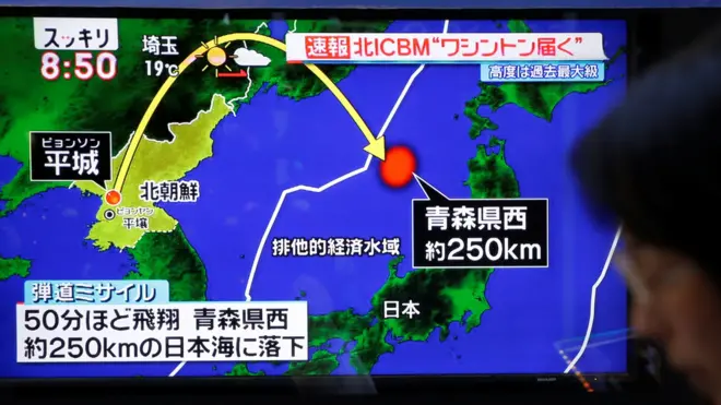 11月29日，一位东京市民经过一个播放朝鲜发射导弹新闻的大屏幕。