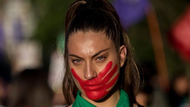 A woman takes part in a march on the eve of the commemoration of the International Day for the Elimination of Violence Against Women, in Santiago, on November 22, 2018