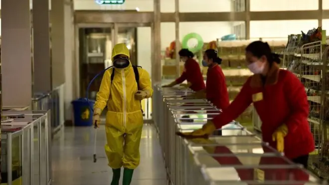 평양의 한 상점에 북한 관계자가 방역을 실시하고 있다