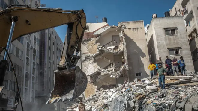 Palestinians inspect a destroyed house, after it was struck by Israeli strikes, in Gaza City, May 16, 2021