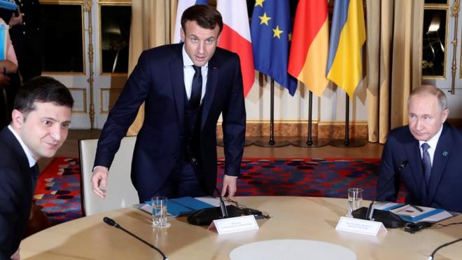 Ukrainian President Volodymyr Zelensky sits down with French President Emmanuel Macron and Russian President Vladimir Putin for a working session in Paris, France 9 December 2019