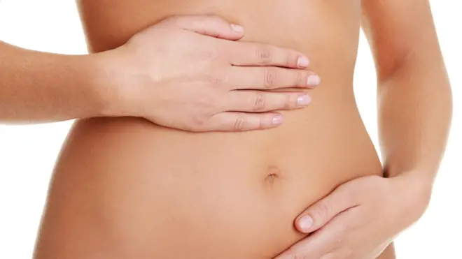 Woman holds stomach