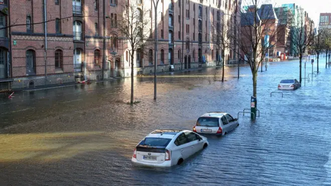 Flood waters surround cars parked at Hamburg's Fish Market district