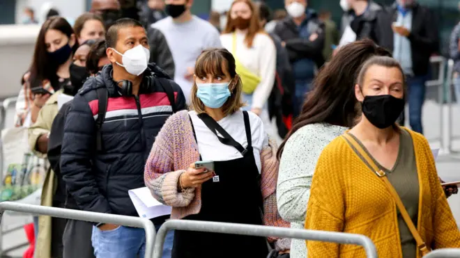 People queue for a dose of the Pfizer Covid-19 vaccine at Tottenham Hotspur Stadium, London, on 20 June 2021