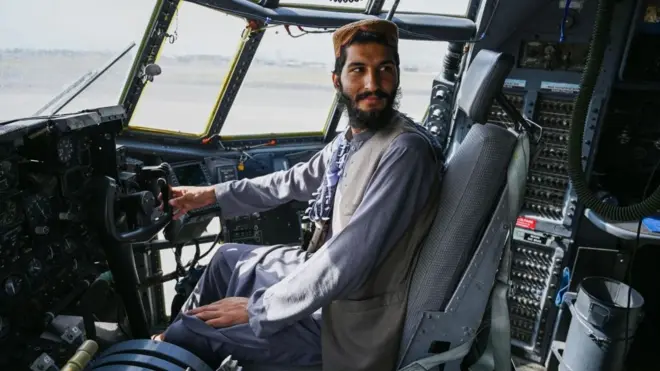Taliban fighter in US aircraft at Kabul Airport