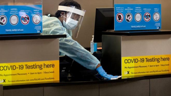 During the global coronavirus pandemic a medical worker cleans the counter in Tom Bradley international at LAX on Tuesday