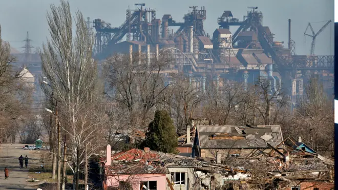 A view shows a plant of Azovstal Iron and Steel Works company behind buildings damaged in the besieged southern port city of Mariupol, Ukraine, on 28 March 2022